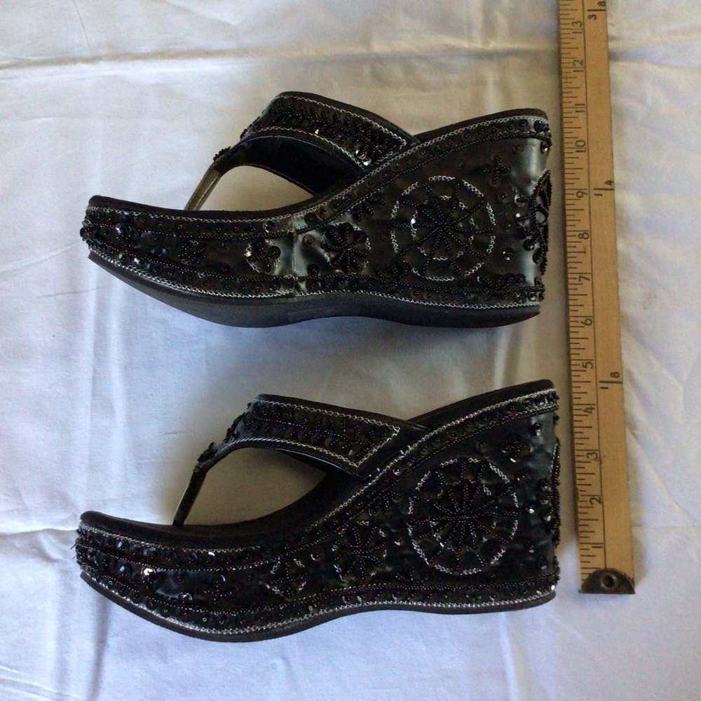 Black and sequined platform sandals.